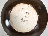 a brown and white plate with writing on it