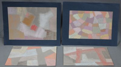 two framed paintings of different colors and shapes on a table