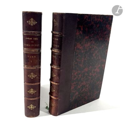 two old books sitting next to each other on a white surface