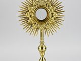 a gold plate with a cross on top of it