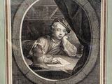 portrait of a young boy reading a book in a round frame