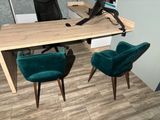 a desk with two chairs and a computer on it