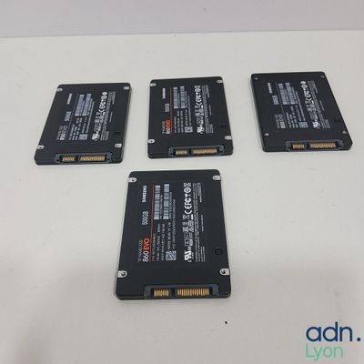 four hard drives sitting on top of a white table next to each other