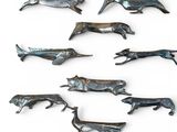 a lot of metal animals that are on a white surface