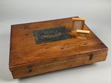 an old wooden box with a book on top of it