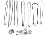 a lot of different types of jewelry on a white surface