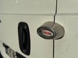 a close up of a door handle on a white van
