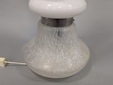 a white lamp that is sitting on a table