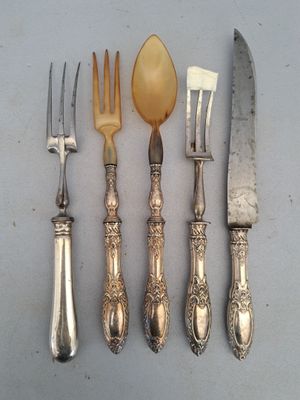five different types of silverware on a table