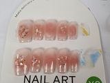 a package of fake nails that are on a white table