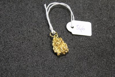 a close up of a gold nugget with a price tag on it
