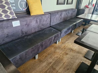 a purple couch with a yellow pillow on top of it