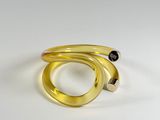 a close up of a gold ring with a black diamond on it