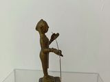 a bronze statue of a man holding a microphone on a glass table