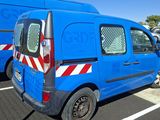 a blue van that is parked in a parking lot