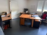 a desk with a chair and a computer on it in a room
