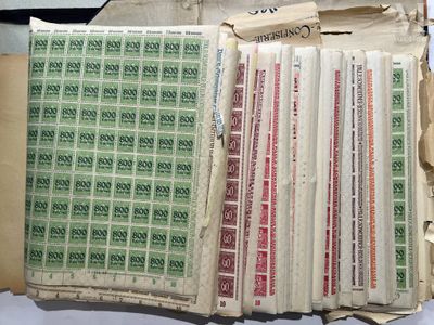 a pile of stamps on a table next to a pile of papers