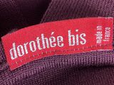 the label on the back of a purple sweater reads, drop the us