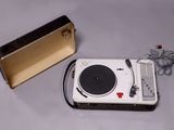 a record player and a speaker on a table