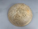 a white bowl with a lid that has a pattern on it
