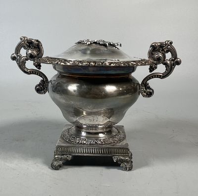 a silver bowl with a lid on a stand