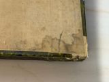 an old book that is sitting on a table