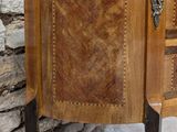 a small wooden cabinet with a marble top on a stand