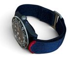 blue and red watch strap with a silver buckle on a white background
