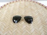 pair of sunglasses laying on top of a woven basket on a table
