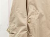 a close up of a beige trench coat on a mannequin mannequin mannequin mannequin mannequin mannequin mannequin mann
