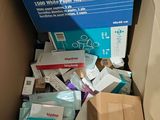 a cardboard box full of medical supplies in the corner of a room