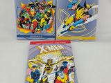 the x - men comic books are sitting on a white surface