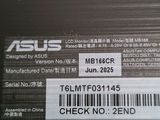 the back of a black laptop with a barcode on it