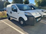 two white vans parked in a parking lot next to each other