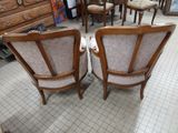 two chairs that are sitting next to each other in a room