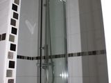 a walk in shower with a glass door in a bathroom