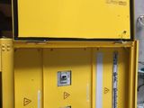 an image of a yellow metal box with electrical equipment inside of it