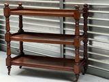 a wooden shelf with three shelves on top of it