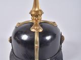 an old helmet with a gold spike on the top of it