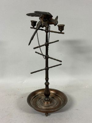 a metal bird on a stand with a chain around it
