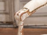 a close up of a chair with a wooden seat