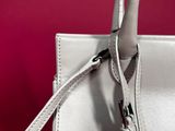 a close up of a white handbag on a pink background
