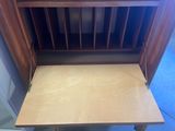 a small wooden desk with a drawer underneath it