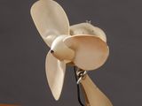 a small white fan sitting on top of a wooden table