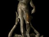 a bronze statue of a man standing on a rock
