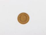 a close up of a gold coin on a white surface