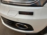 a close up of a white car with a clock on the front of it