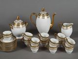a white and gold tea set with cups and saucers
