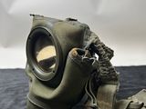 an old gas mask on a black surface