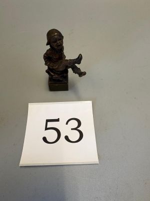 a close up of a small figurine on a table next to a number